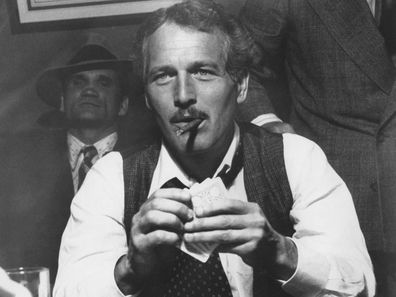 Paul Newman playing poker whilst smoking cigar from the 1973 film 'The Sting' with Charles Dierkop in background.