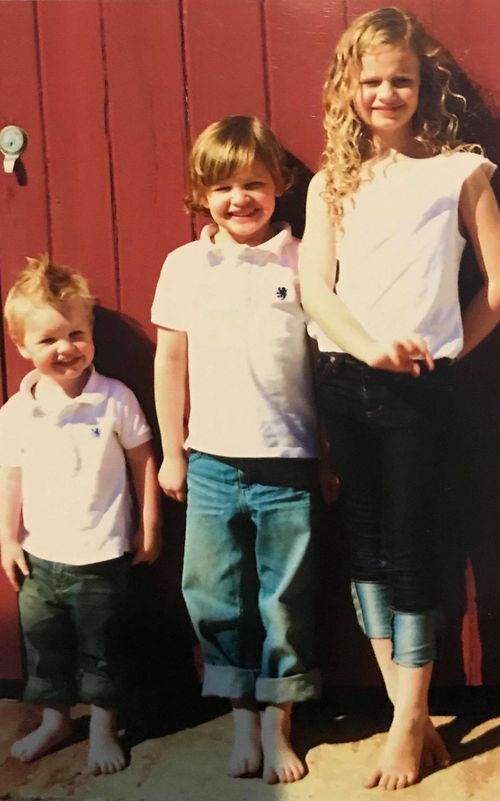Evie (centre) with her younger brother and older sister. 