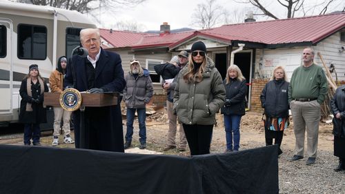 President Donald Trump speaks along side first lady Melania Trump, as they meet with homeowners affected by Hurricane Helene in Swannanoa, N.C., Friday, Jan. 24, 2025. (AP Photo/Mark Schiefelbein)