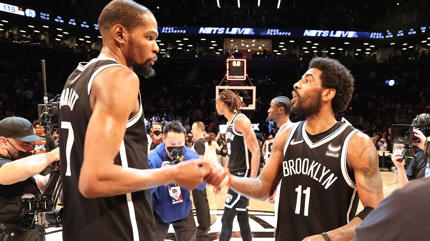 Kevin Durant #7 of the Brooklyn Nets hi-fives Kyrie Irving #11 after the win against Cleveland 