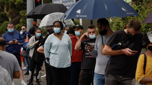 People wait at Kildare Road Medical Centre in Blacktown, Sydney for COVID-19 tests.