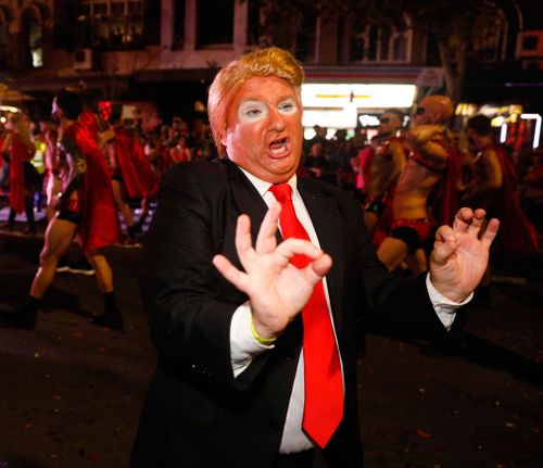 A marcher donned fake tan and a wig for this Donald Trump impersonation. (AAP)