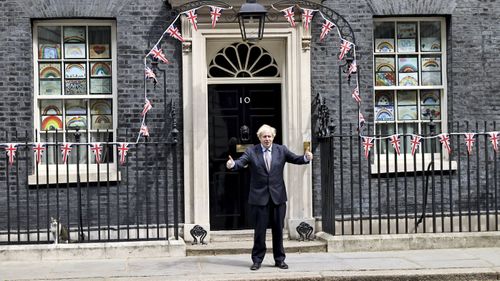 Britain's Prime Minister Boris Johnson poses for the media outside Downing Street, to mark the 75th anniversary of VE Day, in London, Friday, May 8, 2020