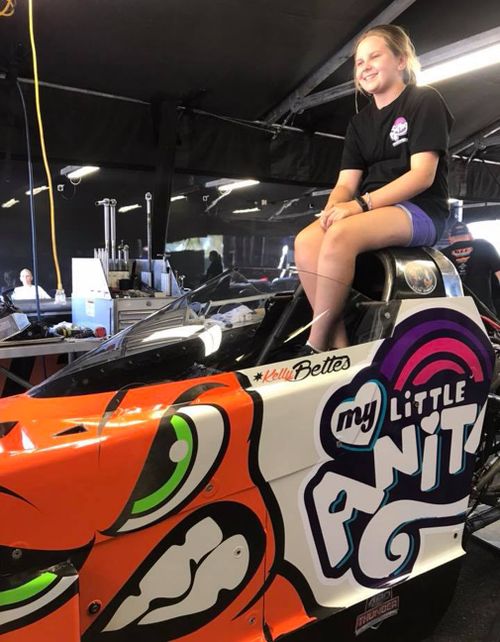 Zara Board sits on the car bearing her late sister's name. (Supplied)