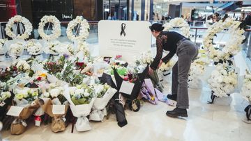 Members of the public pay their respects at the Westfield Bondi Junction shopping centre