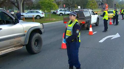 NSW Police stop vehicles and check for permits on the first day of travel, since the Victoria-NSW border was closed.