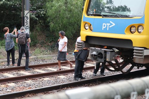 Passengers were helped off the train after a large tree branch fell on it this morning. (AAP)