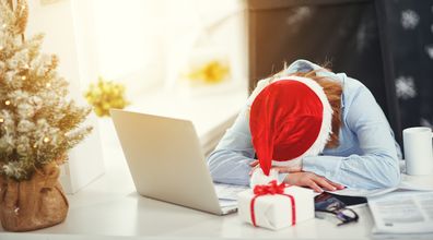 business woman businesswoman freelancer tired, asleep working at computer at Christmas