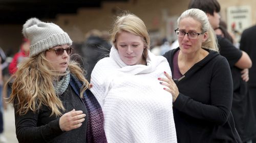 Student from the high school is met by her family after the incident occurred. 