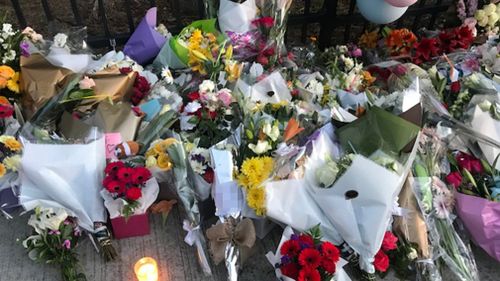 People have been leaving flowers, balloons and cards at the school since yesterday afternoon. (9NEWS)