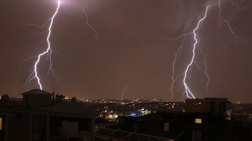 Lightning flashes in the distance as a thunderstorm passes over Istanbul, Turkey last night. (AAP)