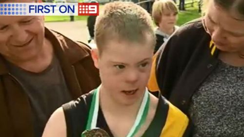 Twelve-year-old Alec with his parents after the game. (9NEWS)