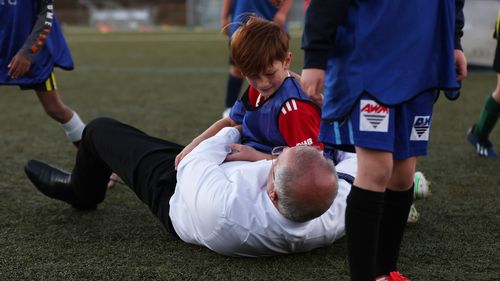 Prime Minister Scott Morrison accidentally knocks over a child during a visit to Devonport Strikers Soccer Club, which is in the Braddon electorate of Devonport, Australia. 
