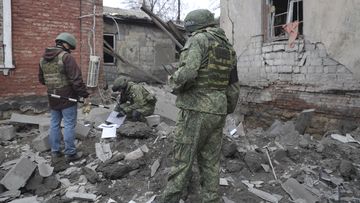 Investigators inspect a site of an apartment building after shelling by Ukrainian forces in Makiivka, Donetsk People&#x27;s Republic, eastern Ukraine, Friday, Nov. 4, 2022.