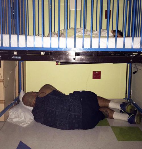 Dad captured sleeping under sick child’s hospital cot in moving photo