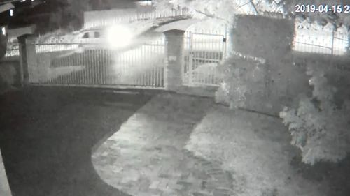 CCTV of a light-coloured car near the scene of the shooting.