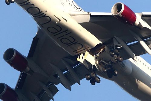 A close up of the jumbo jet's undercarriage showing the malfunctioning starboard-side landing gear. (Getty)
