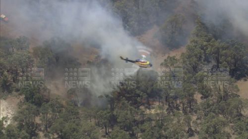 Firefighters are tackling a fast-moving bushfire threatening two communities north-east of Perth.