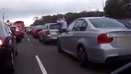 At one point, the man in the blue shirt had the man wearing the white shirt in a headlock (Dash Cam Owners Australia)