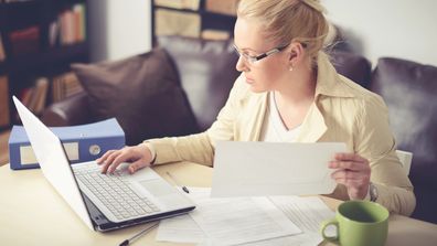 woman sitting at the table and working at home