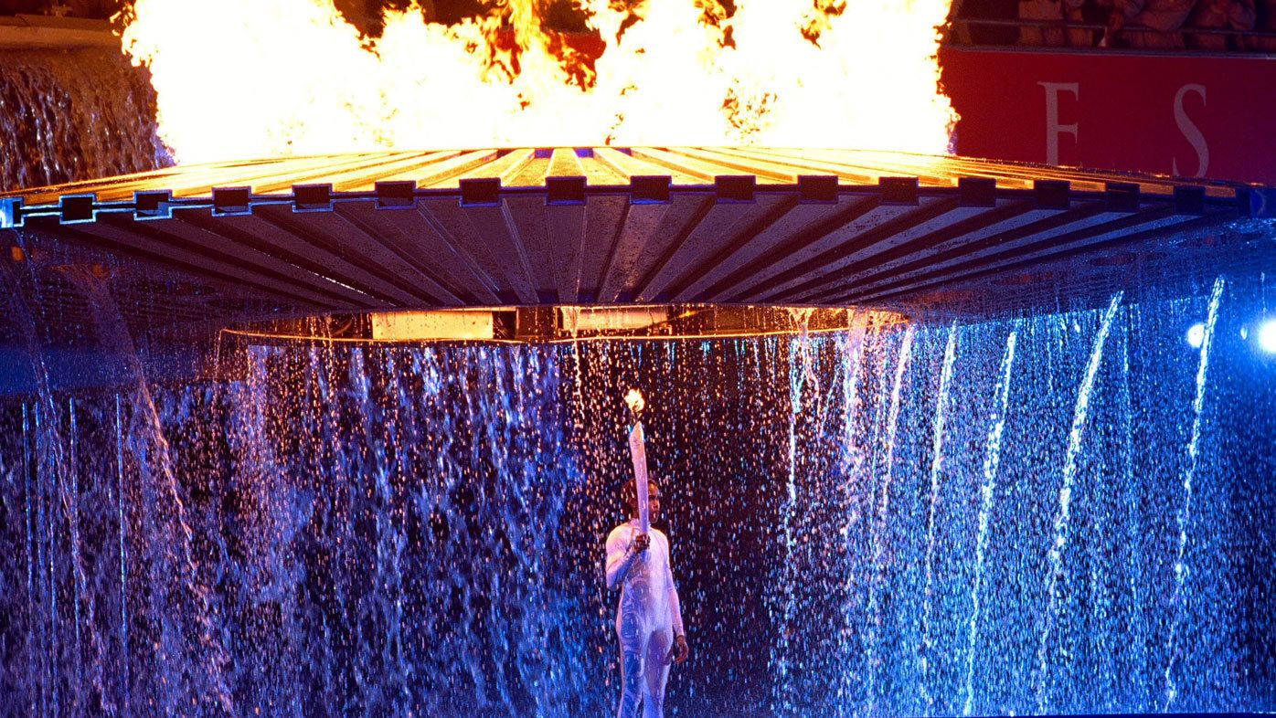 Cathy Freeman stands with the Olympic torch after lighting the cauldron during the opening ceremony of the Sydney 2000 Olympic Games.