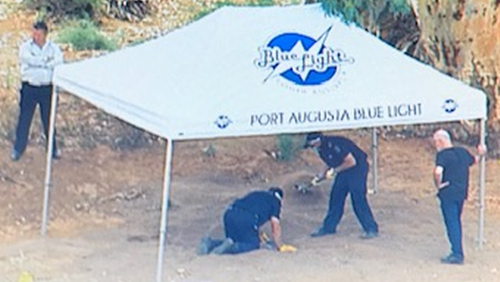 Forensic police examine the site of a suspected shallow grave in the Flinders Rangers.