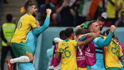 Australia players celebrate after Mathew Leckie scored to give the side a 1-0 lead over Denmark.
