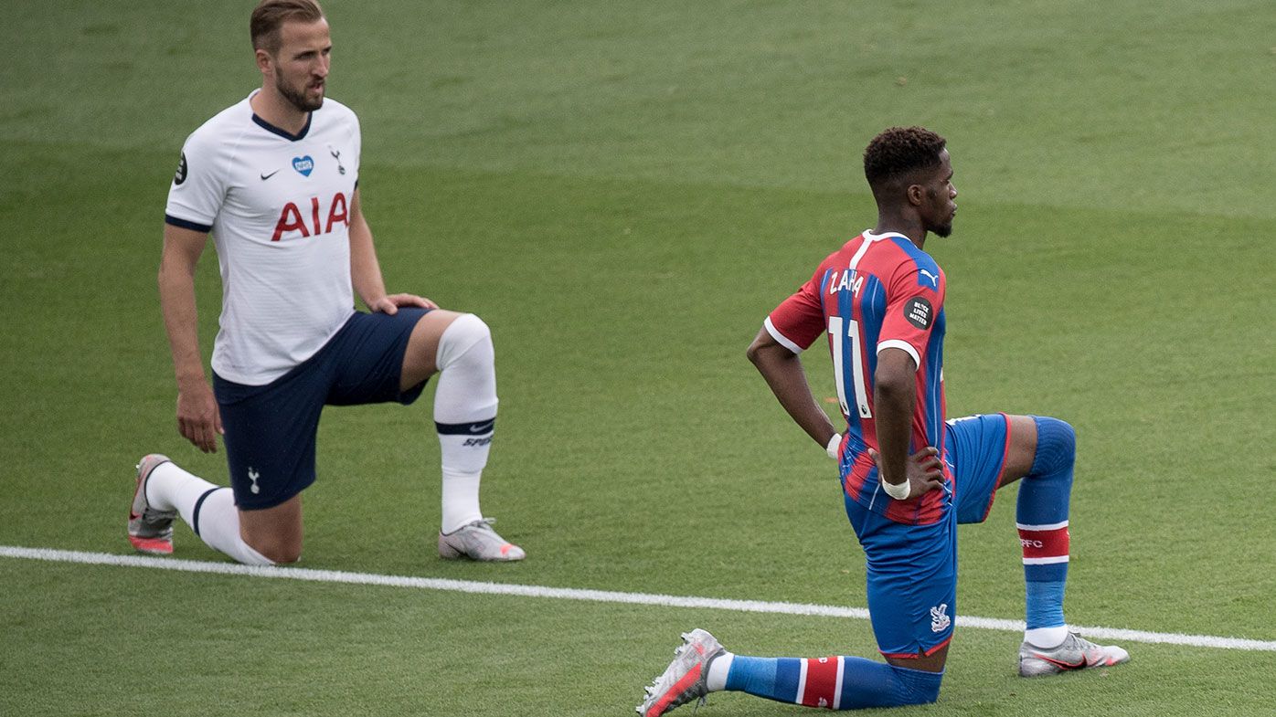 Harry Kane of Tottenham Hotspur and Wilfried Zaha of Crystal Palace take a knee during the Premier League match between Crystal Palace and Tottenham Hotspur 
