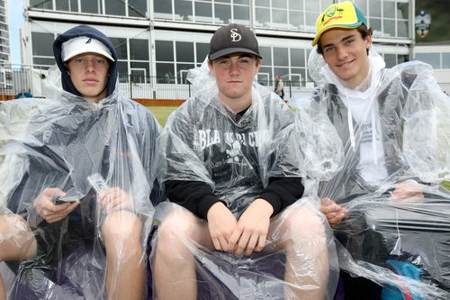 Fans aren't put off by the rain this morning as they wait for an almost inevitable Australian win. Picture: AAP