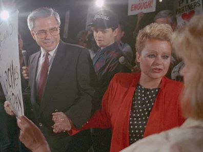 Jim Bakker and wife Tammy Faye Bakker greet supporters as they leave federal court in Charlotte. 