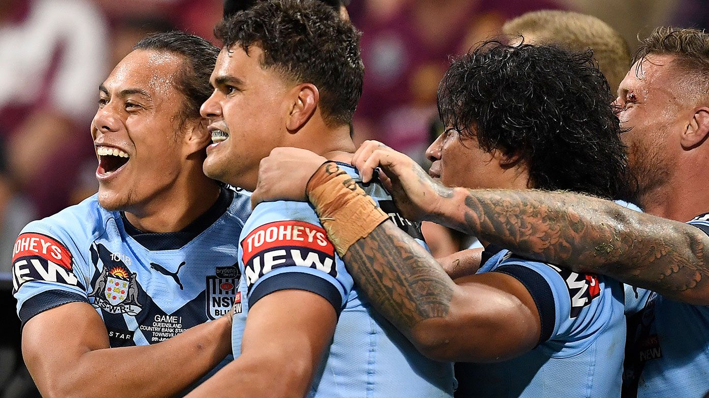  Latrell Mitchell of the Blues celebrates with team mates after scoring a try during game one of the 2021 State of Origin series between the New South Wales Blues and the Queensland Maroons at Queensland Country Bank Stadium on June 09, 2021 in Townsville, Australia. (Photo by Ian Hitchcock/Getty Images)