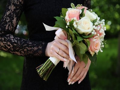 Goth bride holding flowers