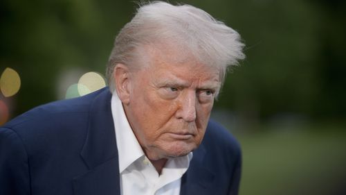 President Donald Trump speaks with reporters after disembarking Marine One upon arrival on the South Lawn of the White House in Washington, Sunday, May 4, 2025. (AP Photo/Rod Lamkey, Jr.)