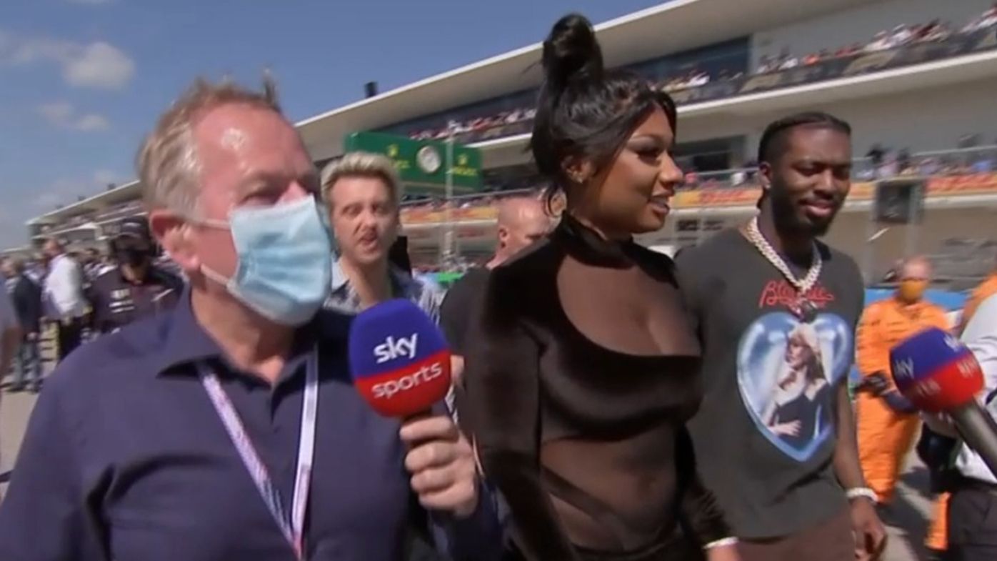 Martin Brundle attempts to talk to rapper Megan Thee Stallion at the US Grand Prix.
