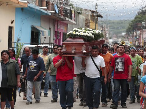 Locals carry the casket of a woman who died in Tuesday's earthquake, in Tlayacapan, Morelos state. (AP)