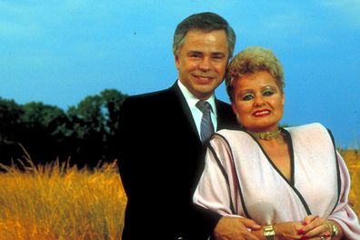 Former televangelists Jim and Tammy Faye Bakker standing in the middle of a wheat field.  (Photo by Will And Deni McIntyre/Getty Images)