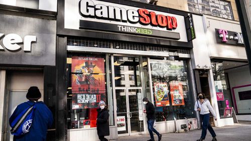 Les piétons passent un magasin GameStop sur la 14e rue à Union Square, New York.