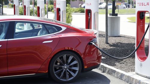 The Tesla Model S is plugged in at a vehicle Supercharging station 