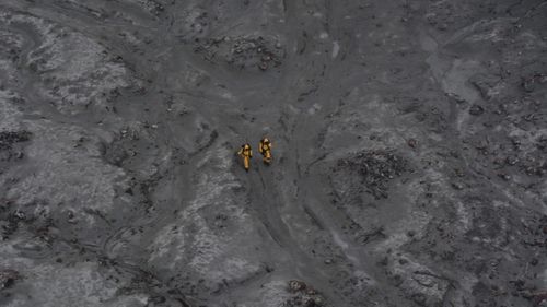 The recovery team wore hazardous material suits to protect themselves from toxic gases.