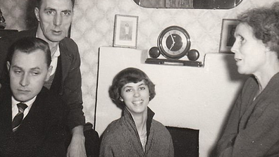 The Hitchings family sit in the front room of their Battersea property in 1957. 