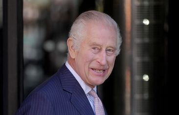 King Charles III smiles as he arrives for a visit to University College Hospital Macmillan Cancer Centre in London, Tuesday, April 30, 2024. 