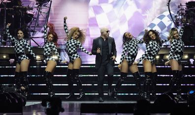 LAS VEGAS, NEVADA - NOVEMBER 24: Pitbull (C) performs with members of his dance troupe The Most Bad Ones during a stop of The Trilogy Tour at T-Mobile Arena on November 24, 2023 in Las Vegas, Nevada. (Photo by Ethan Miller/Getty Images)