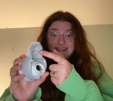 Woman showing off her water bottle lid where the mould was.