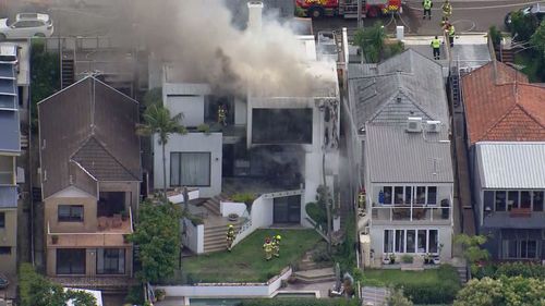 Firefighters have rushed to a multi-million dollar house in Sydney after it caught fire on Boxing Day.Flames were seen coming from the three-level home on Kent Street in Waverley﻿, near Bondi.