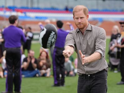 Prince Harry, Duke of Sussex, hits a sherrin ball during a Western Bulldogs Australian rules football session at the Western Bulldogs headquarters at Mission Whitten Oval, in Footscray, a suburb of Melbourne, Australia, Wednesday, April 15, 2026. (Jonathan Brady/Pool Photo via AP)
