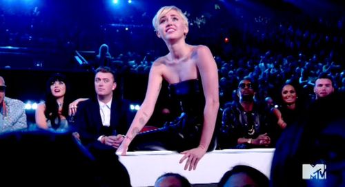 Miley Cyrus watches her proxy walk on stage to accept her MTV Video Music Awards gong for video of the year. (Twitter)