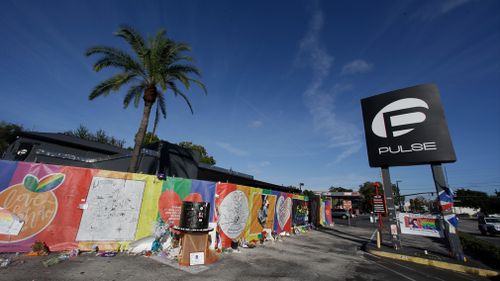 Artwork and signatures cover a fence around the Pulse nightclub, the scene of the mass shooting. (AP)