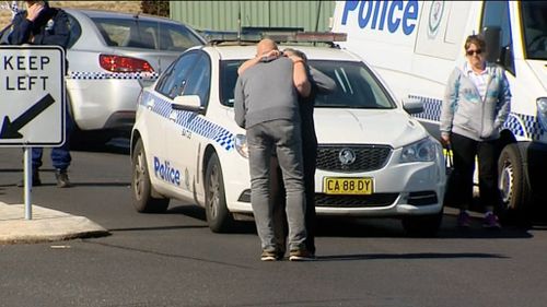 Family and friends gathered outside the couple's home yesterday. (9NEWS)