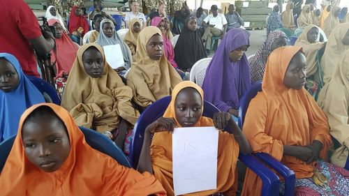The girls from the Government Girls Science and Technical College Dapchi who were kidnapped and set free are photographed during a hand over to government officials in Maiduguri, Nigeria. (AAP)