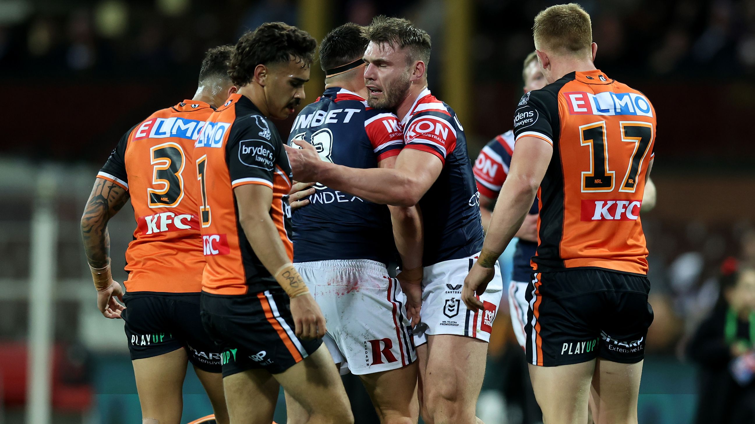 Angus Crichton of the Roosters celebrates a try as the beaten Tigers watch on.